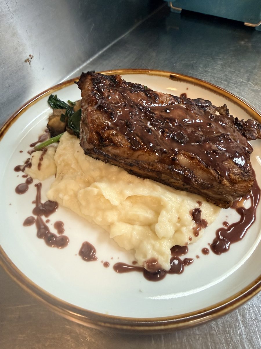 13 oz New York steak with brandy sauce over garlic mashed potato