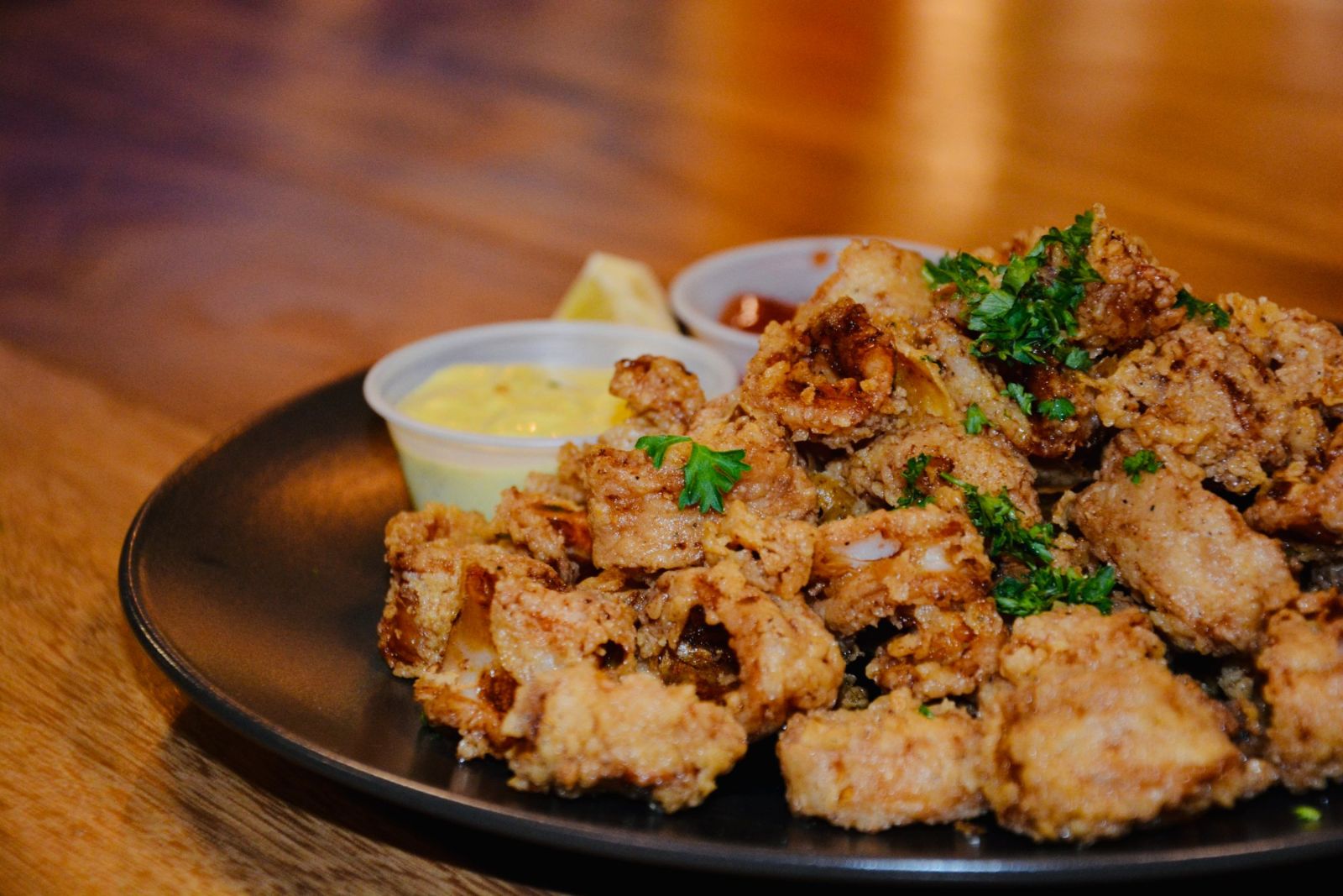 Crispy fried calamari with dipping sauces and lemon
