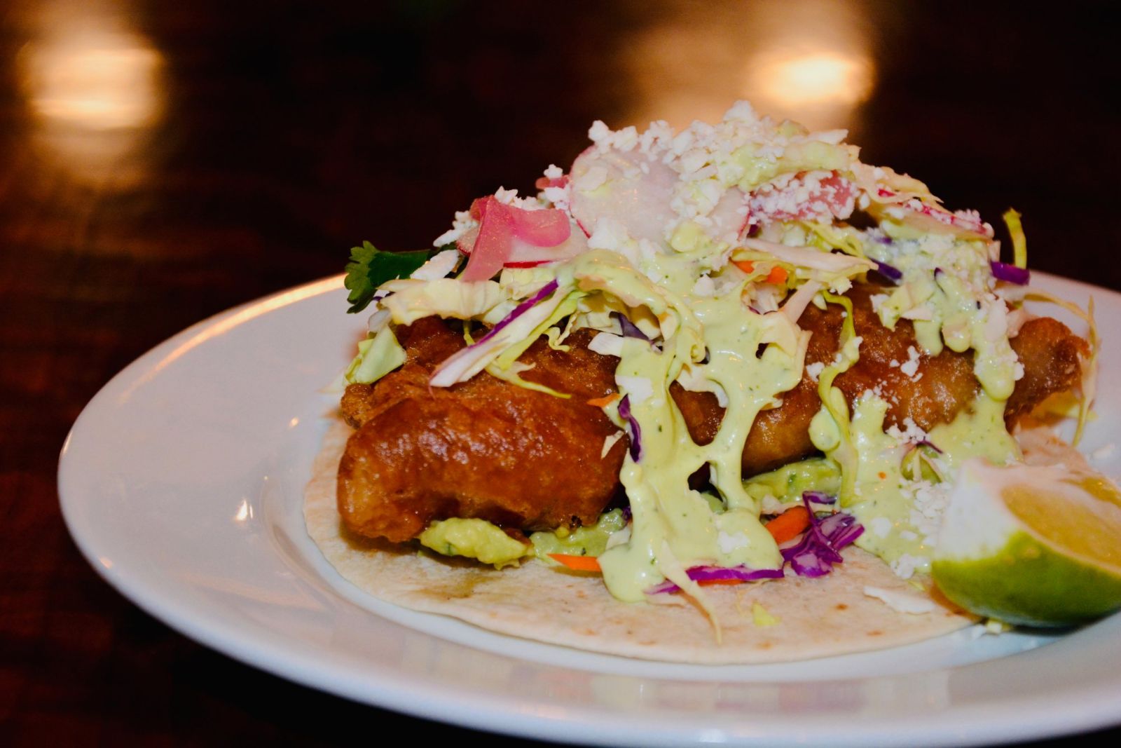 Beer-battered rockfish taco with slaw, cotija and lime
